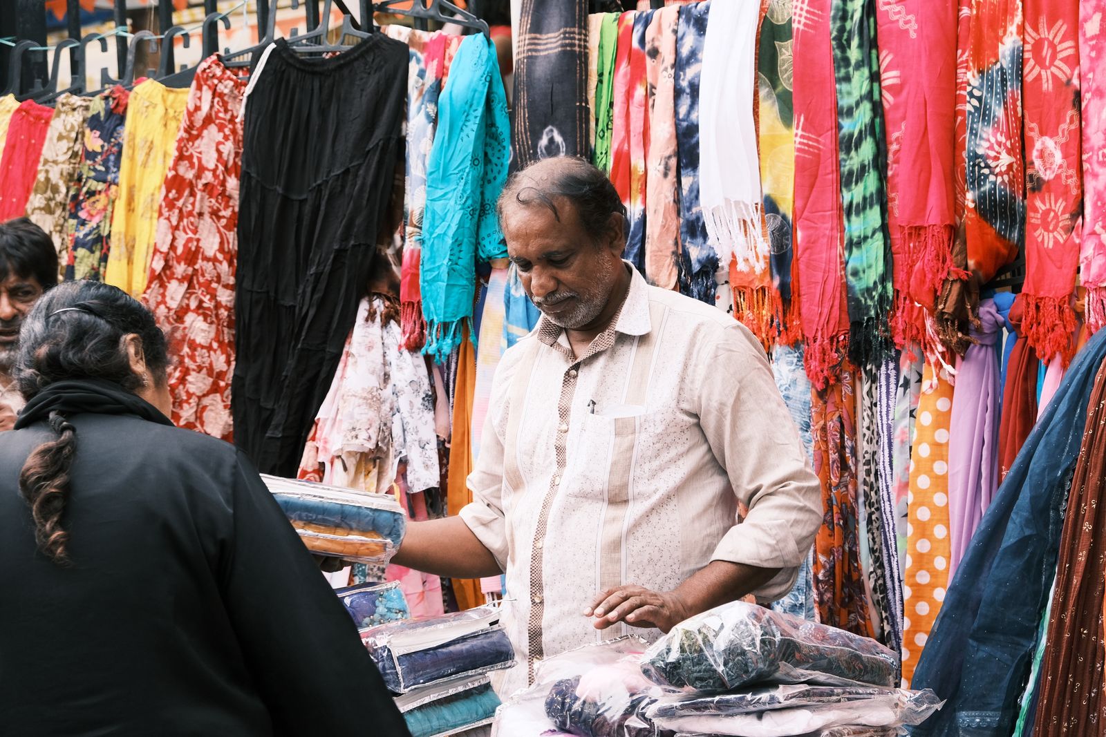 Indian shopkeeper working inside his local shop